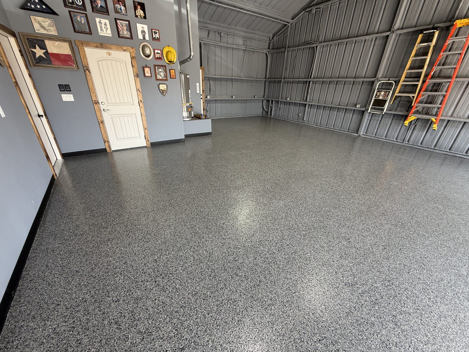 Barndominium garage bay with finished epoxy flake floor in Dodd City, TX