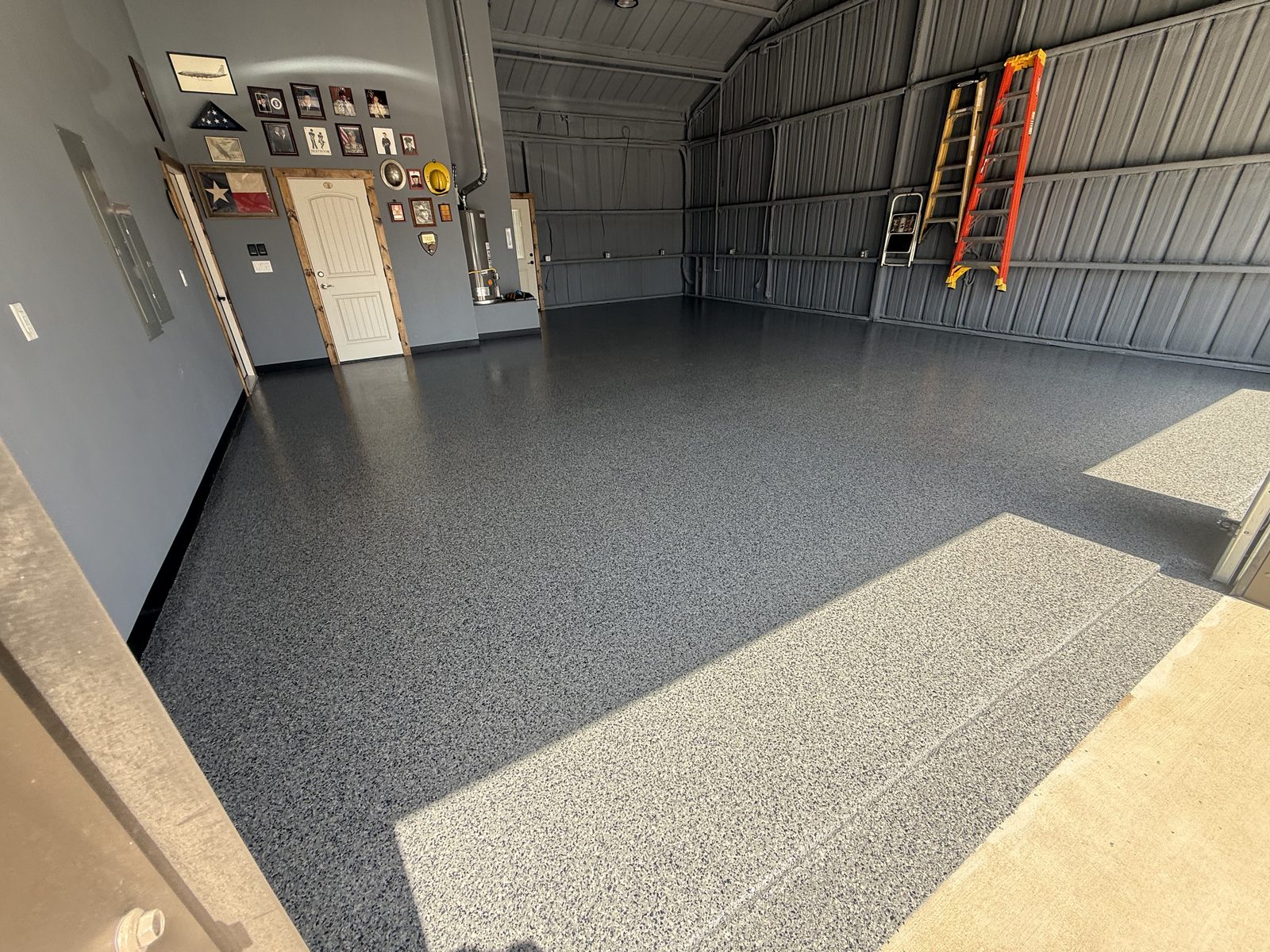 Close up of flake epoxy floor edge detail at garage door, Dodd City TX
