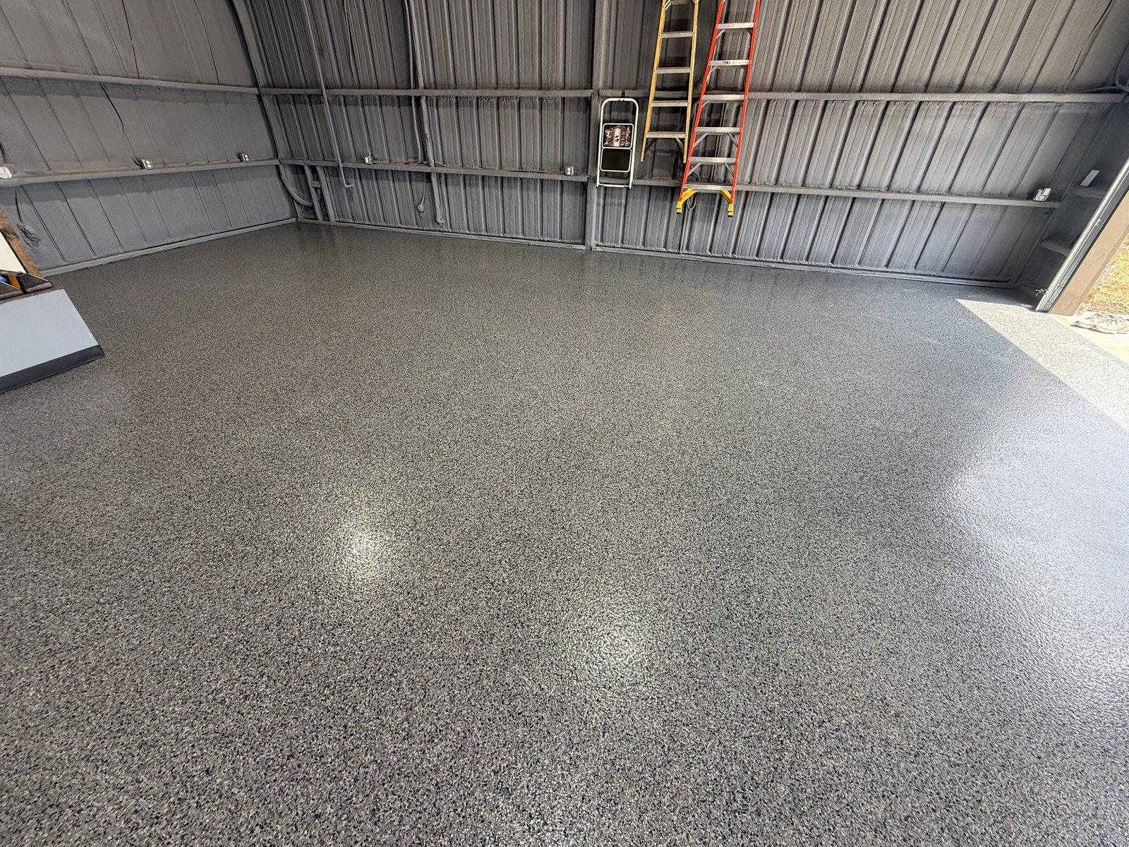 Torginol Nightfall flake epoxy floor on a barndominium garage in Dodd City, TX