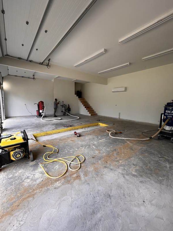 Before epoxy floor — raw concrete being diamond ground