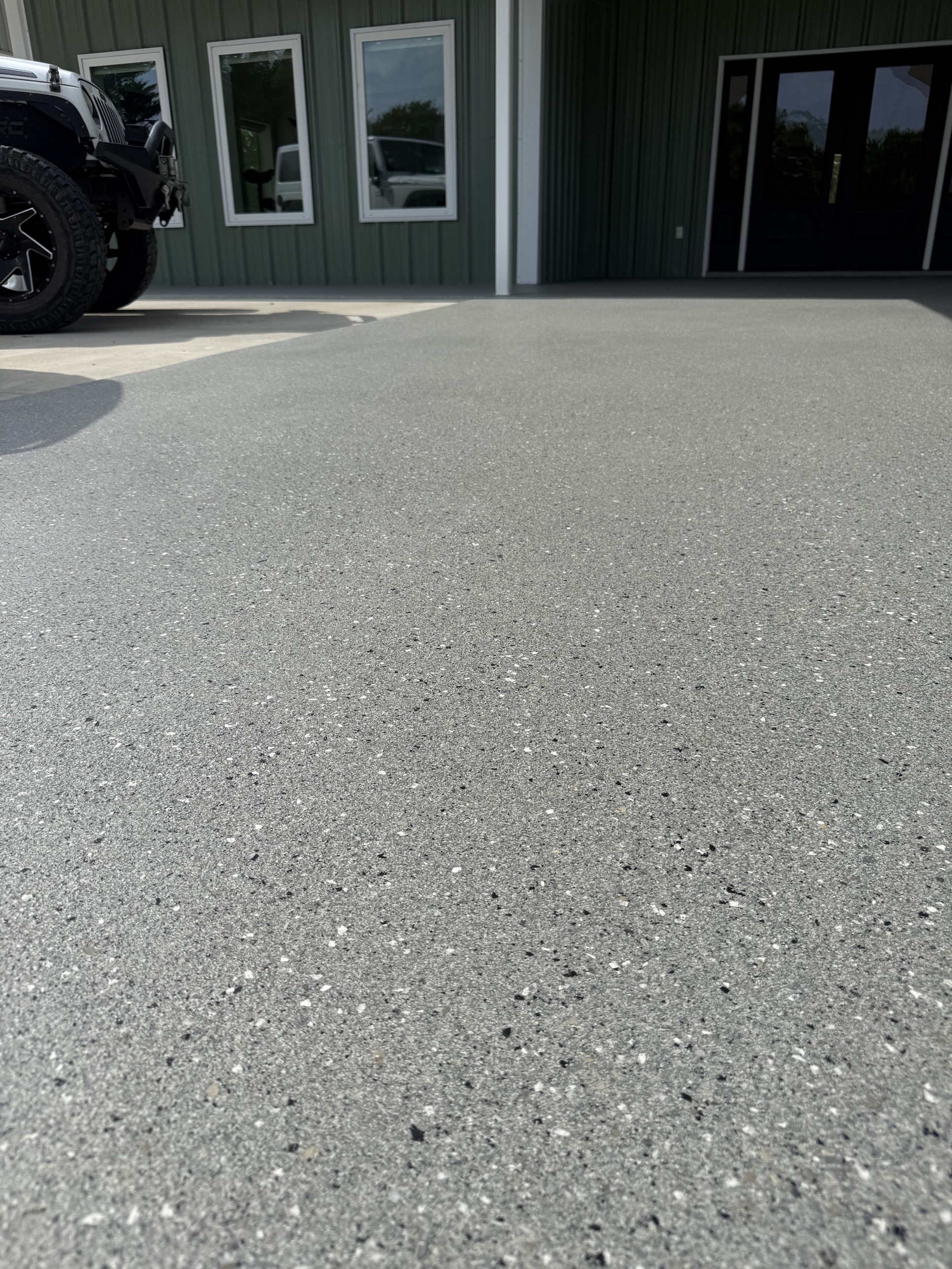 Covered patio floor outside a Sherman metal building
